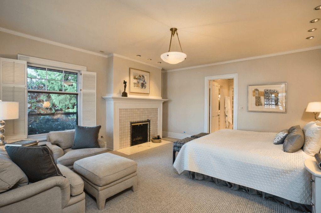 Cozy bedroom with fireplace and textured carpet