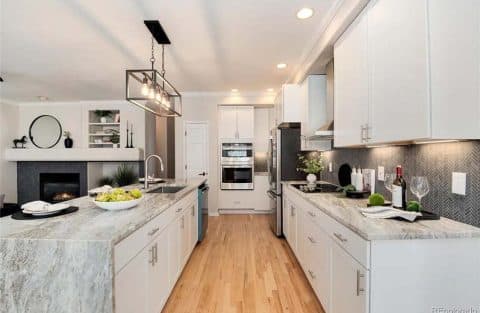 Kitchen with herringbone backsplash and stainless appliances