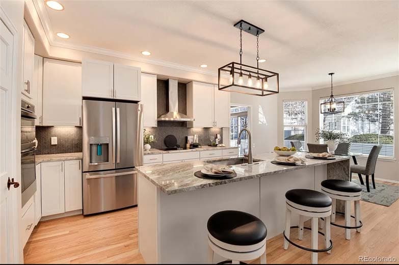 Wide kitchen shot with island and pendant lights